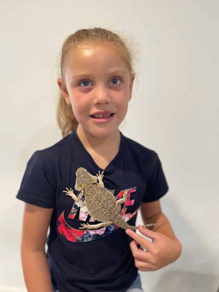 Little Girl holding a Lizard — Frozen Feeders in NSW